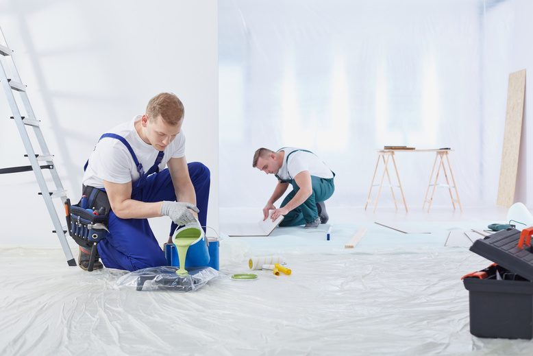 professional painters preparing to paint office in commercial building