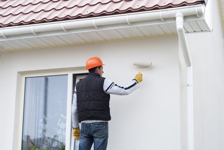 professional painter painting home exterior